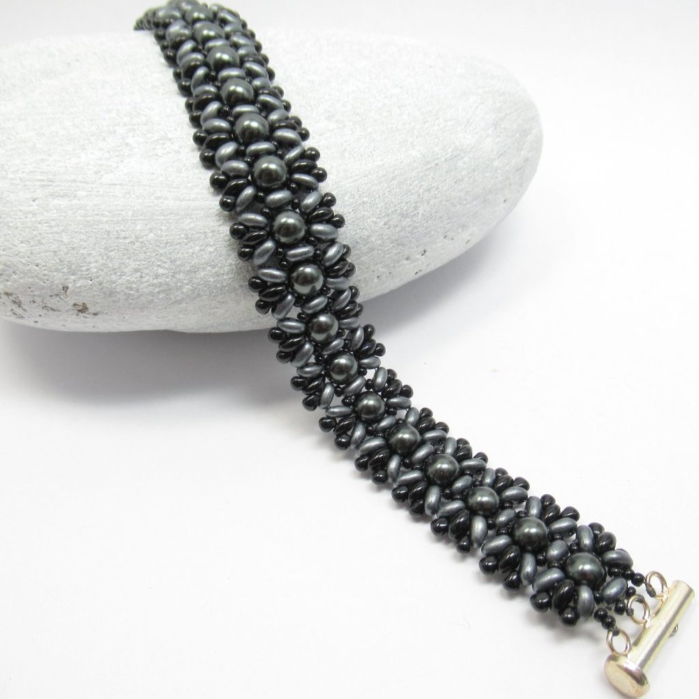 Hand woven bracelet with dark grey Swarovski pearls